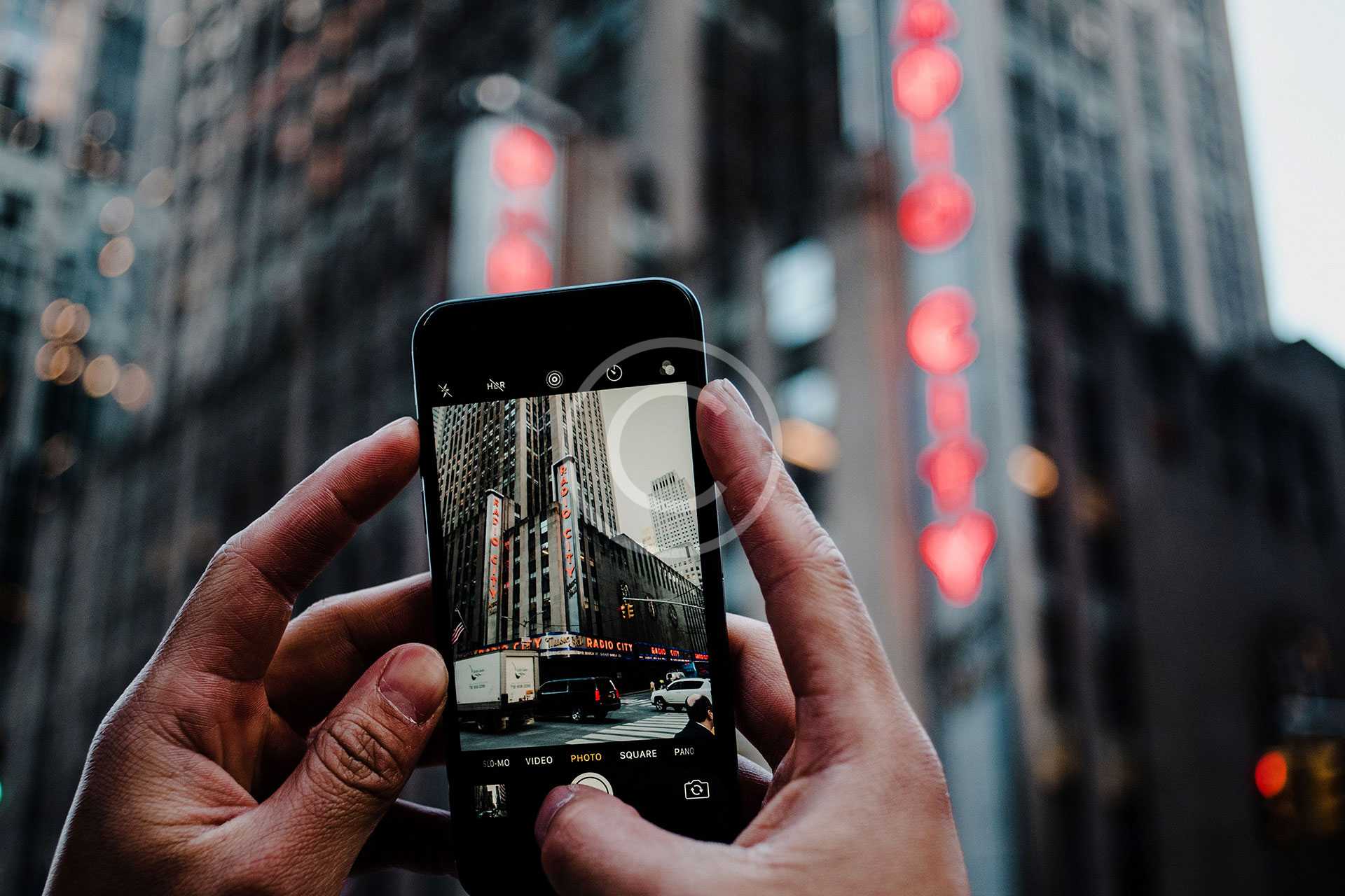 men capturing tall building photo