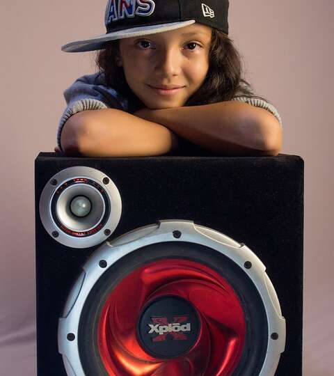 baby girl posing on speaker buffer