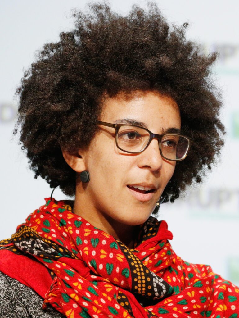 Artificial intelligence researcher Timnit Gebru speaking onstage in 2018