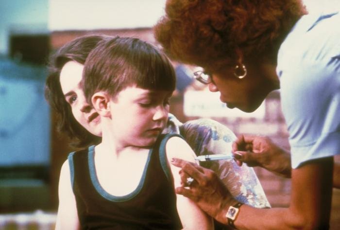 A health worker administering a vaccine to a child