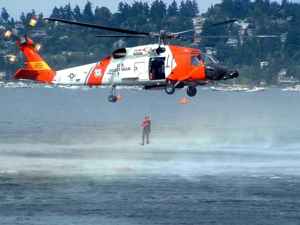 U.S. Coast Guard helicopter during a rescue demonstration over open water; illustrative image, not the aircraft involved