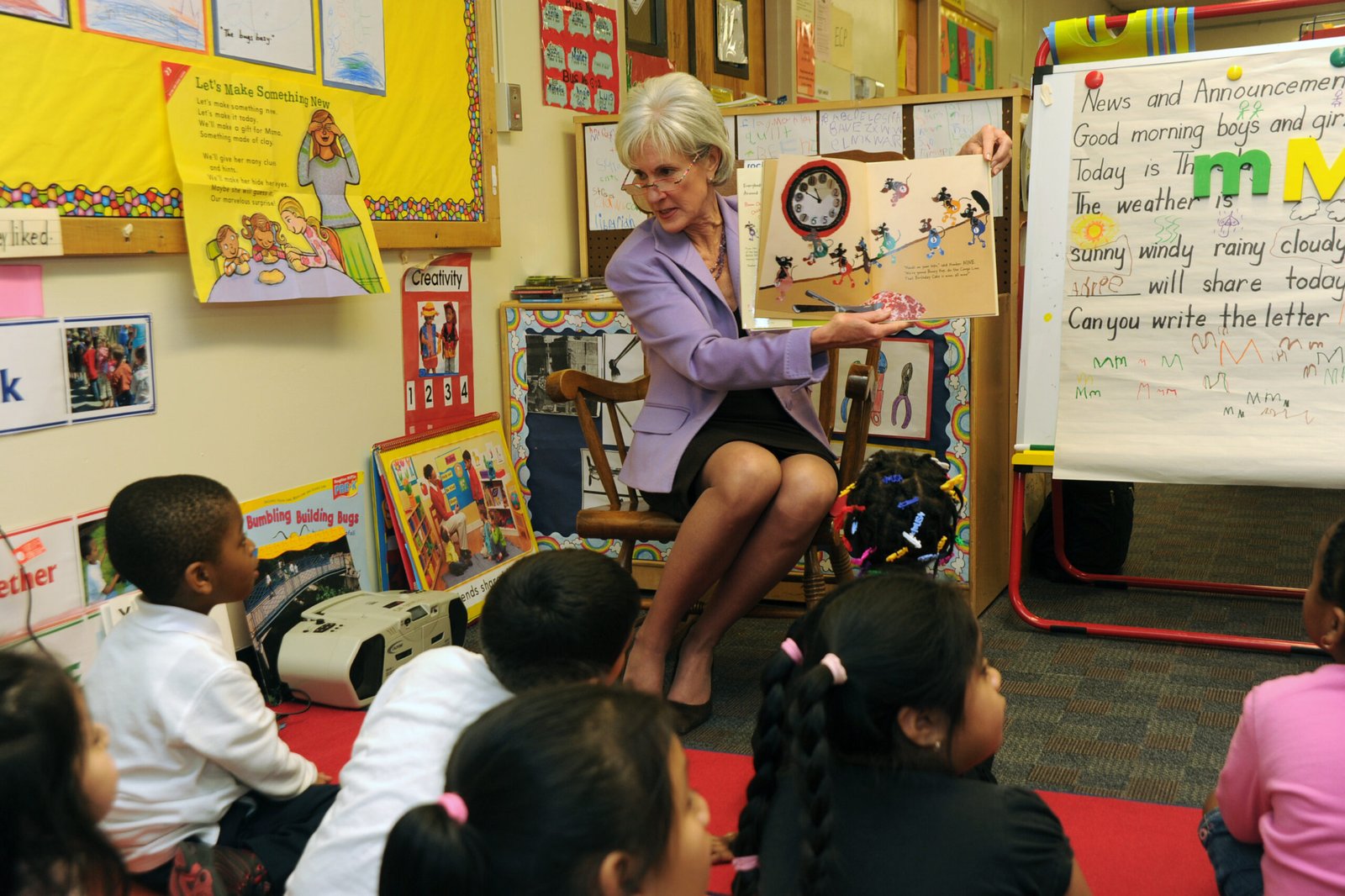 An adult reading to a group of four-year-old Head Start students