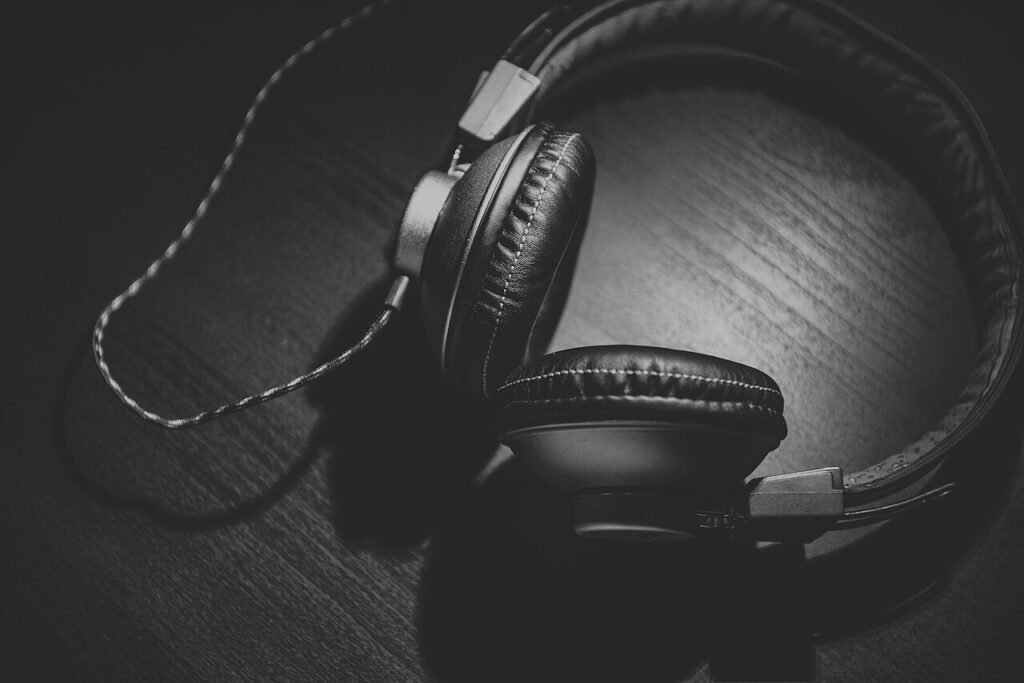 Black-and-white photograph of headphones on wood