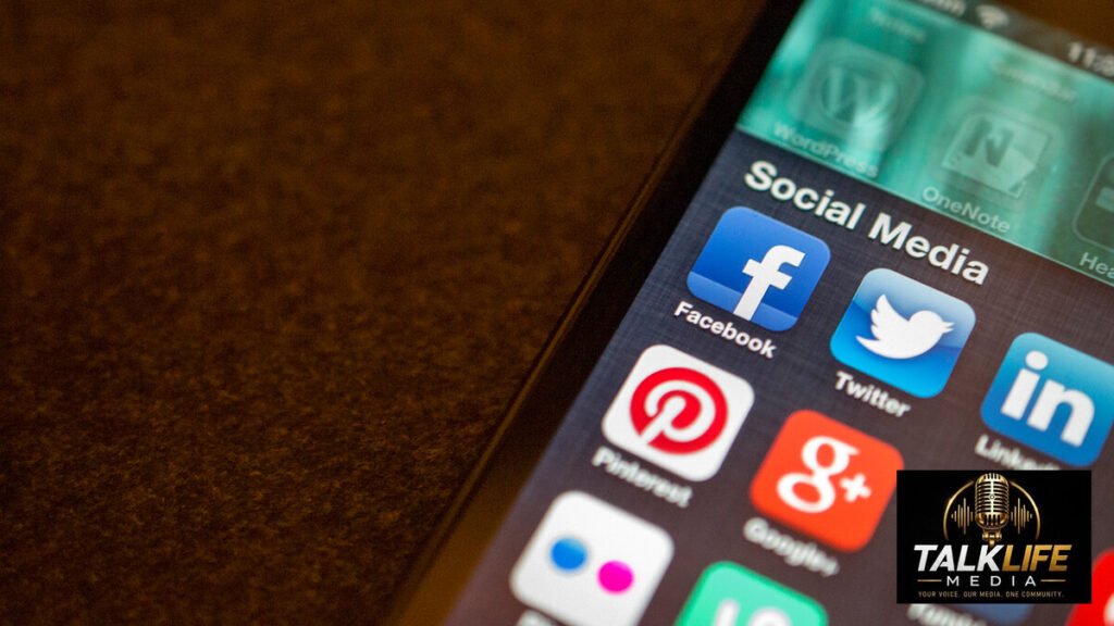 Smartphone displaying social-media applications with Talk Life Media logo